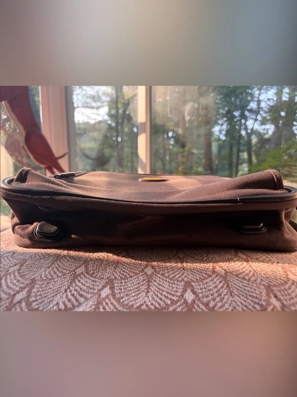 Eddie Bauer army green carry-on bag with black hand straps and shoulder strap